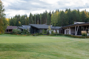 Obraz premium Row of new houses or cottages in rural environment with vast green lawn in front