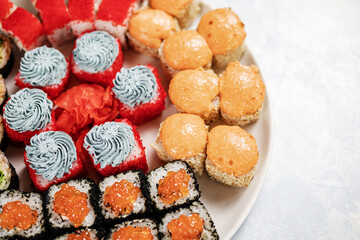 rolls and sushi on a blue sky bright light background top view