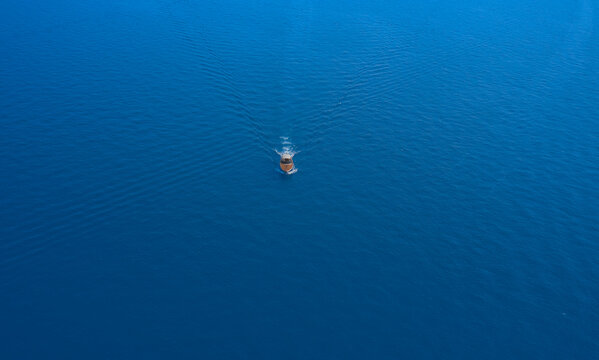 Aerial view luxury motor yacht. Yachts at the sea surface.Travel - image.High-speed yacht of white color fast motion on blue water in the rays of the sun top view.