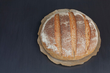 Homemade sourdough bread on a black background with copy space.