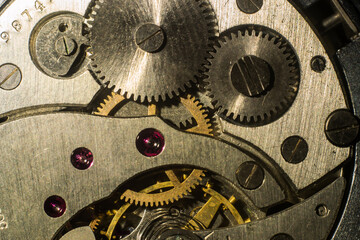 Fototapeta na wymiar closeup of the gears of an antique clockwork