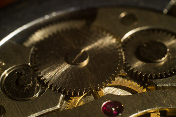 closeup of the gears of an antique clockwork