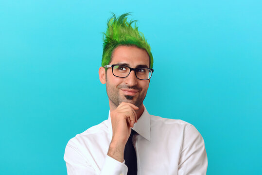 Creative businessman with green hair thinks about a crazy project