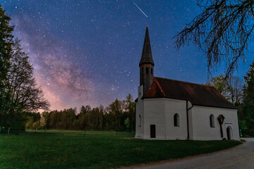 Fototapeta na wymiar The impressive Milkyway, stars to dream, a wonderful starry night in front of a little chapel in southern germany
