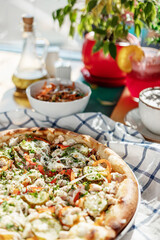 pizza on a checkered napkin in a cafe on the table natural sunlight