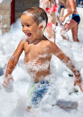 Little boy plays in foam