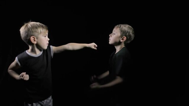 Athletes in black T-shirts perform punches and blocks on a black background