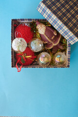 Christmas Decoration In A Box, some different christmas ornaments in a box, on a blue background