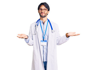 Fototapeta na wymiar Handsome hispanic man wearing doctor uniform and stethoscope clueless and confused expression with arms and hands raised. doubt concept.