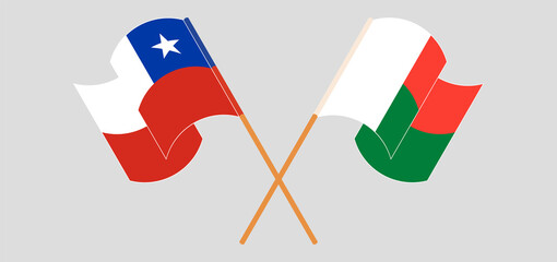 Crossed and waving flags of Madagascar and Chile