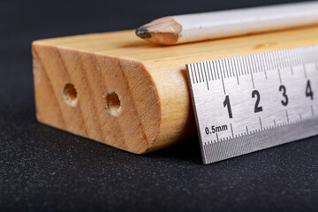 A protractor and a metal ruler to measure angles in a carpentry workshop. Accessories for measuring...