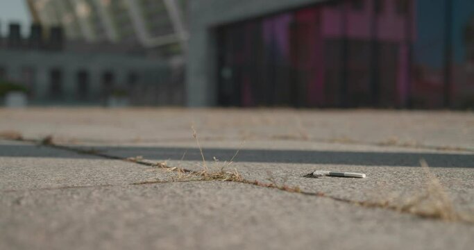 Male stubbing cigarette out by foot on the street, unhealthy habit, addiction