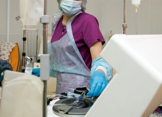 A nurse is preparing a blood transfusion apparatus.