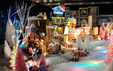 Fototapeta na wymiar Santa Clause house, xmas holidays, Christmas time, street in snow, miniature of winter scene with houses, people, trees, Christmas concept.