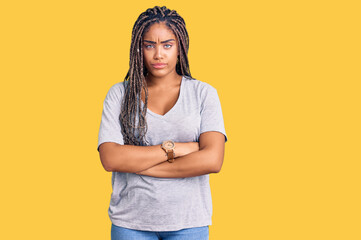 Young african american woman with braids wearing casual clothes skeptic and nervous, disapproving...