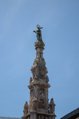 Fototapeta na wymiar Baroque column known as Guglia dell Immacolata or Our Lady of the Immaculate Conception in Naples, Italy
