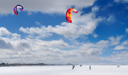 Boarder and skier snowkiting on Lake Simcoe