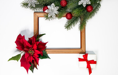 Fototapeta na wymiar Christmas decorations. Wooden frame and fir branches with decorations on white background