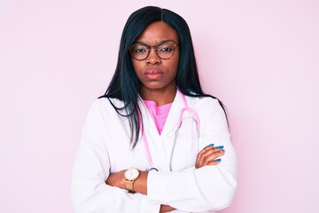 Young african american woman wearing doctor stethoscope skeptic and nervous, disapproving...