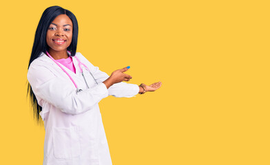 Young african american woman wearing doctor stethoscope inviting to enter smiling natural with open...