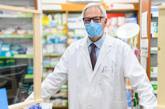 Senior Pharmacist Wearing A Protective Mask In His Store, Coronavirus Concept