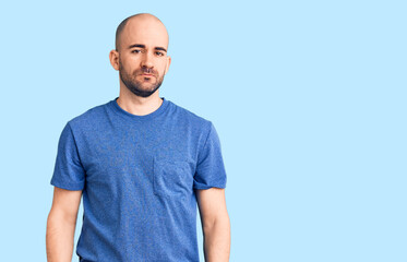 Fototapeta premium Young handsome man wearing casual t shirt relaxed with serious expression on face. simple and natural looking at the camera.