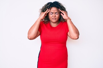 Naklejka premium Young african american plus size woman wearing casual clothes with hand on head for pain in head because stress. suffering migraine.