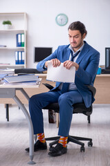 Young male employee unhappy with excessive work