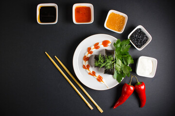 A set of sushi rolls is served on a dark background. Japanese menu. Delicious traditional japanese...