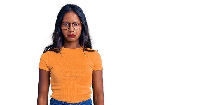 Young indian girl wearing casual clothes and glasses depressed and worry for distress, crying angry and afraid. sad expression.