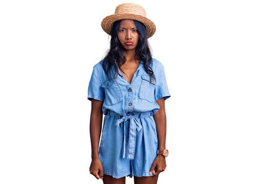 Young indian girl wearing summer hat depressed and worry for distress, crying angry and afraid. sad expression.