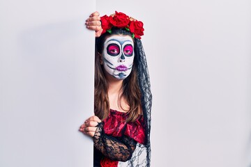 Young woman wearing day of the dead custome holding blank empty banner depressed and worry for distress, crying angry and afraid. sad expression.