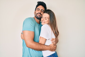 Beautiful young couple of boyfriend and girlfriend together hugging oneself happy and positive, smiling confident. self love and self care