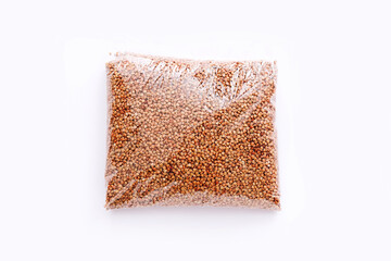 Buckwheat groats in a plastic bag on white background, top view