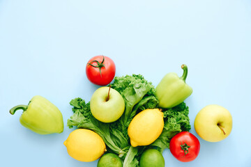 Various fresh vegetables and fruits on blue background. Ingredients for cooking.