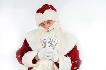 Santa Claus holds money in his hands. Isolated on light background