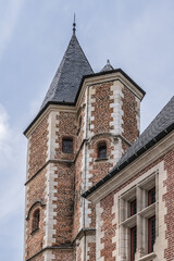 Fototapeta na wymiar Beautiful architecture of ancient French buildings: Logis du Roi (from beginning of XVI century) - brick and stone building with tower, former hotel Trois-Cailloux. Amiens, Picardy, Somme, France.