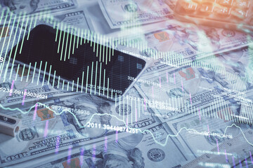 Fototapeta premium Double exposure of forex graph drawing over us dollars bill background. Concept of financial markets.