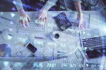 Double exposure of man and woman working together and financial chart hologram drawing. market analysis concept. Computer background. Top View.