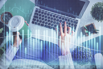 Double exposure of woman hands working on computer and forex chart hologram drawing. Top View. Financial analysis concept.