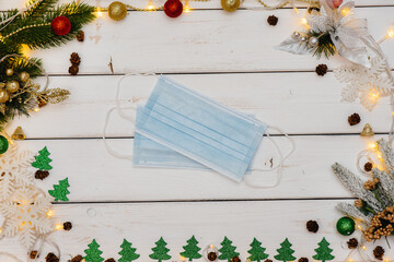 Medical mask on a white Christmas background. Christmas card