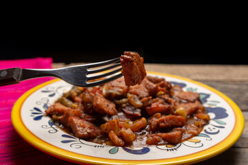 Pork chops with red sauce also called mexicana style on wooden background