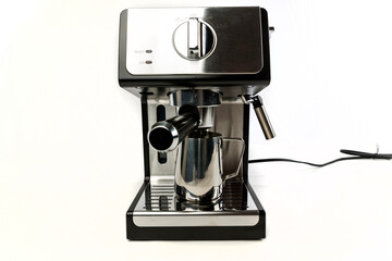 Espresso machine with filter in place and steaming cup below holder head on view