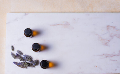 Essential organic lavender oil in small brown glass bottles. Dried flowers .. Concept of natural cosmetics