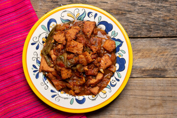 Pork chops with red sauce also called mexicana style on wooden background