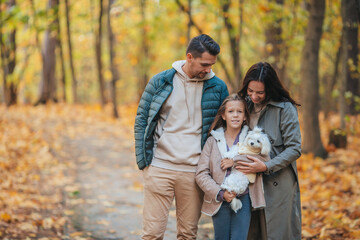Fototapeta premium Portrait of happy family of three in autumn day