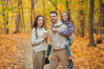Fototapeta premium Portrait of happy family of three in autumn day