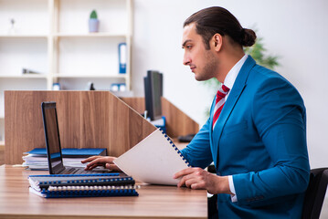 Young male employee working in the office