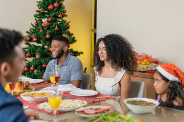 Summer Christmas dinner in Brazil. Real Brazilian family having fun at the Latin American Christmas party. latin couple celebrating christmas