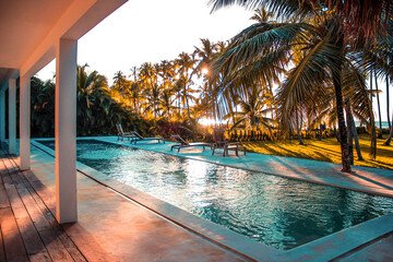 Fototapeta premium SUNSET IN THE CARIBBEAN, SEEN FROM THE POOL AREA OF A LUXURY VILLA